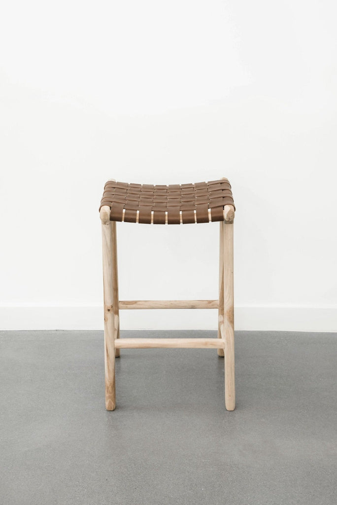 Upclose view of our comfortable, casual, leather-strapped counter height Backless Woven Leather Counter dining stool. Handmade in Bali using Teak wood and vegetable-tanned leather imported from Java. - Saffron and Poe