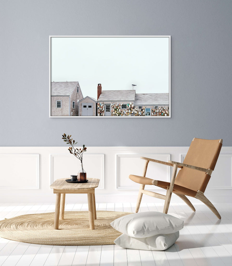 Photo hung in room of seaside house with buoys hung on side by Mika Street for Saffron and Poe