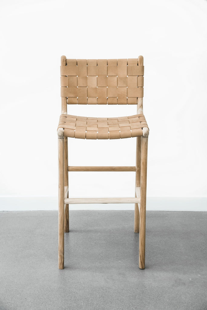 Upclose view of our comfortable, casual, Woven leather strap bar stool in beige. Handmade in Bali using Teak wood and vegetable-tanned leather imported from Java. - Saffron and Poe