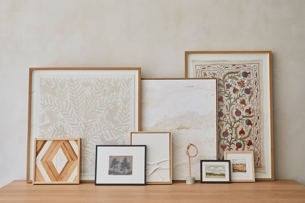 Kaleen Cameron Plaster Abstract Painting on a natural beige lime-wash background layered with various art pieces.