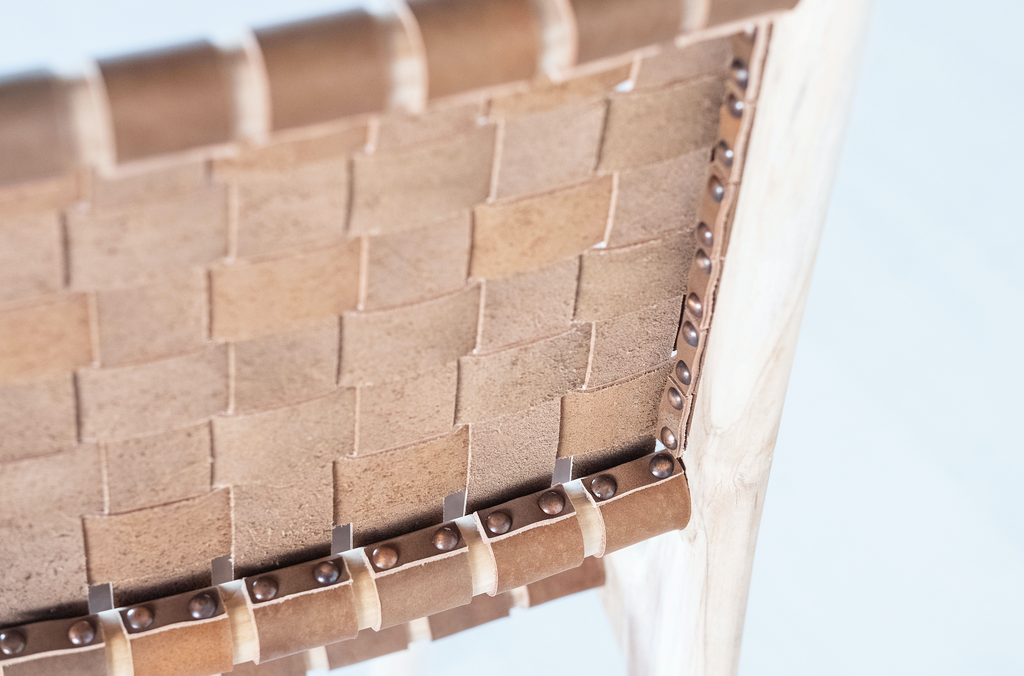 Detailed rear view of our Woven Leather Strap Dining Chair - Saddle on white background. Handmade in Bali with Teak wood and vegetable-tanned leather imported from Java. - Saffron and Poe