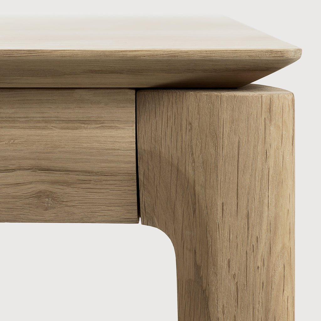 White Oak Bok Dining Table detail with white background featuring floating table top and beautiful wood joinery. - Saffron and Poe, Ethnicraft