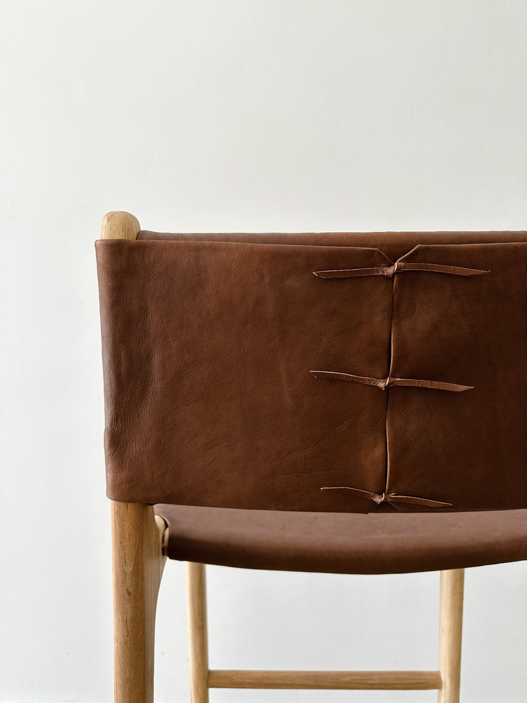 Detailed view of leather ties on the Wrapped Leather Counter Stool. - Saffron and Poe