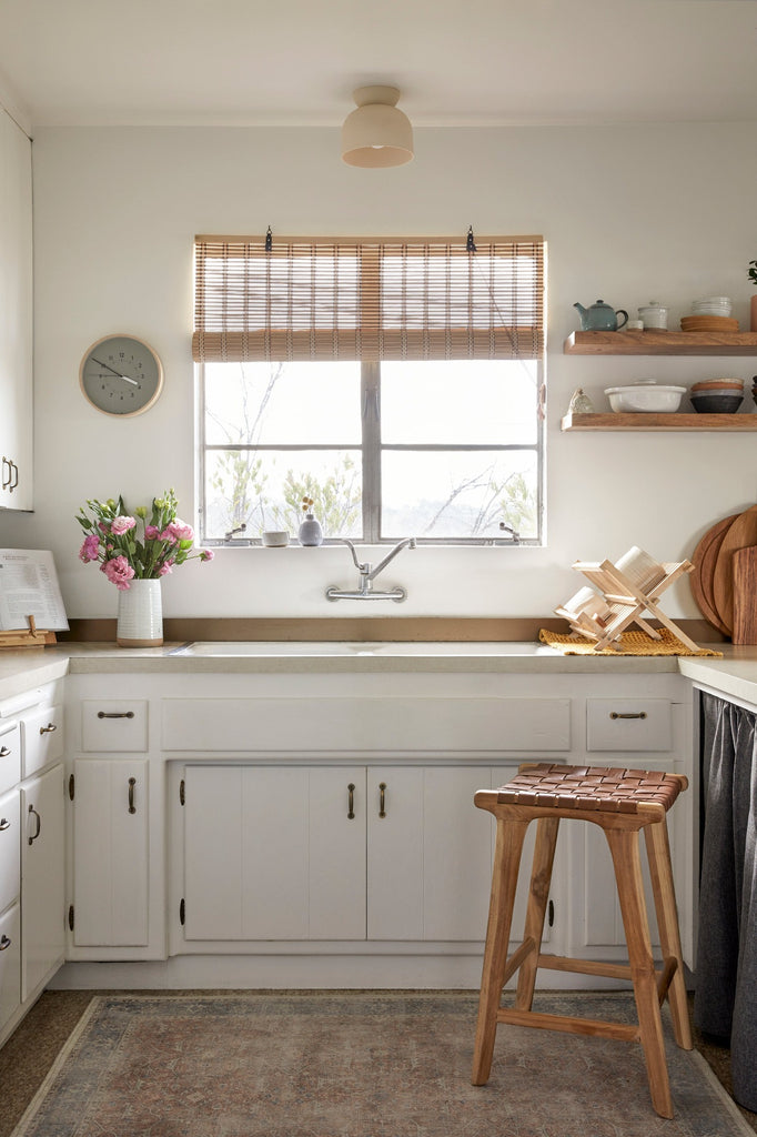 Backless Woven Leather Counter Stool in Saddle styled in a kitchen setting with Ceramic Vase. - Saffron and Poe