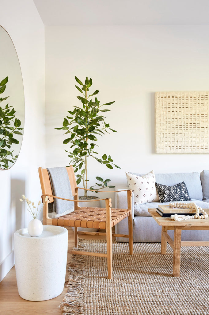 Safari Longe Chair styled in a living room setting with Vintage Coffee Table, Brown Checkered Pillow, Miao Lumbar Pillow, and Abalone Terrazzo Side Table. - Saffron and Poe