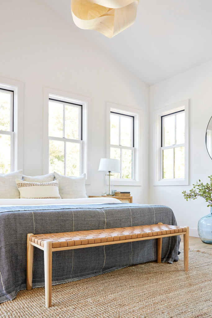 Woven Leather Bench in Beige styled in a bedroom setting. - Saffron and Poe