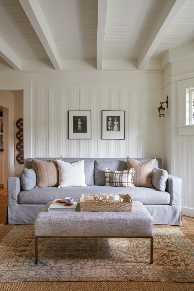Lombok Basket Tray styled in a living room setting with Beige Embroidered Pillow, Ivory Pillow, and Bhujodi Lumbar Pillow. - Saffron and Poe