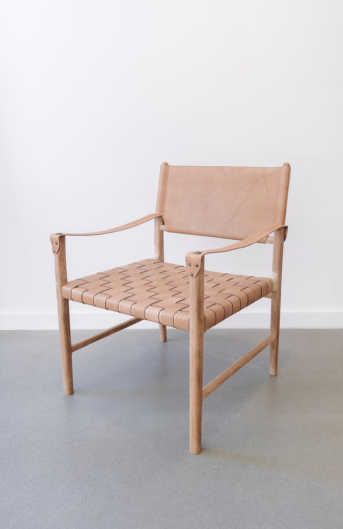 Side view of Leather Strap Safari Lounge - Beige - against a white wall. Handcrafted in Bali. Teak wood and leather straps. - Saffron and Poe