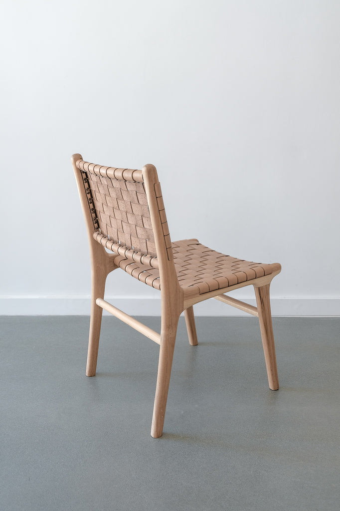 Woven Leather Strap Dining Chair - Beige - Saffron + Poe simple beige neutral chair against white wall Handmade in Bali using Teak wood and vegetable-tanned leather imported from Java.