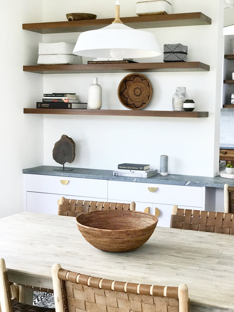 Woven Tenganan accent storage basket styled in kitchen for fruit bowl with wood shelves. Handwoven in Tenganan, Bali using Ata reed on a white background. - Saffron and Poe