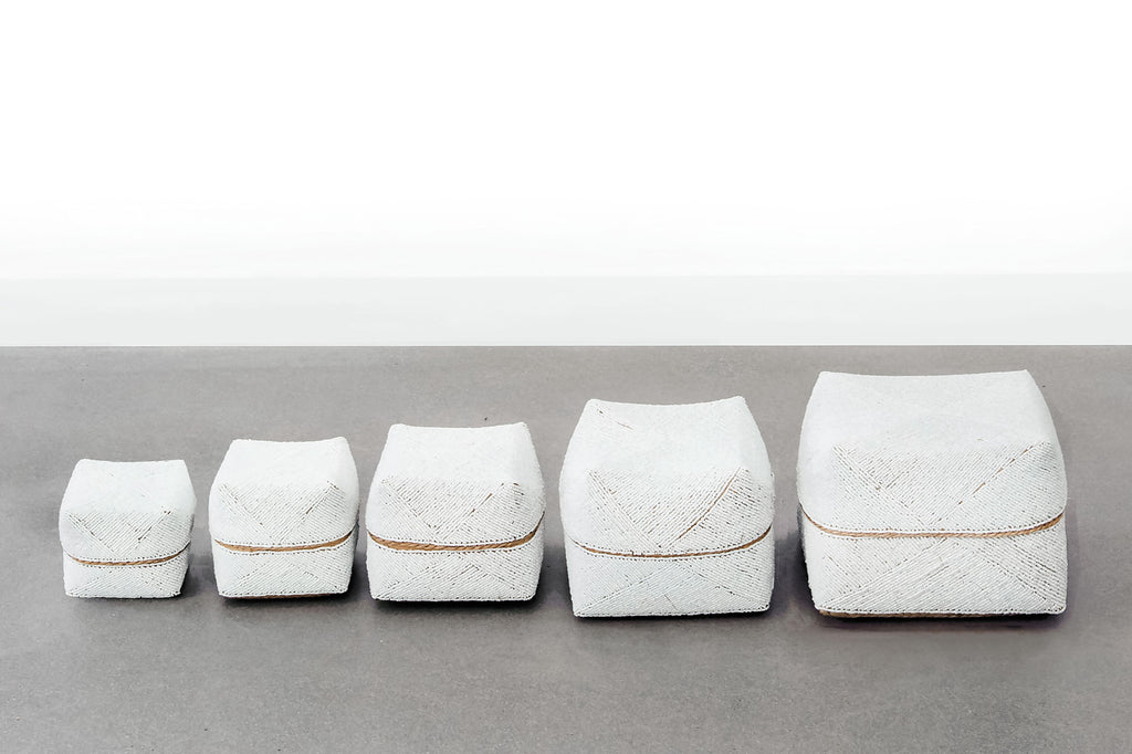 Five Hand-Beaded Bali Storage Baskets in Solid White lined in a row. Handmade in Bali using woven bamboo- Saffron and Poe