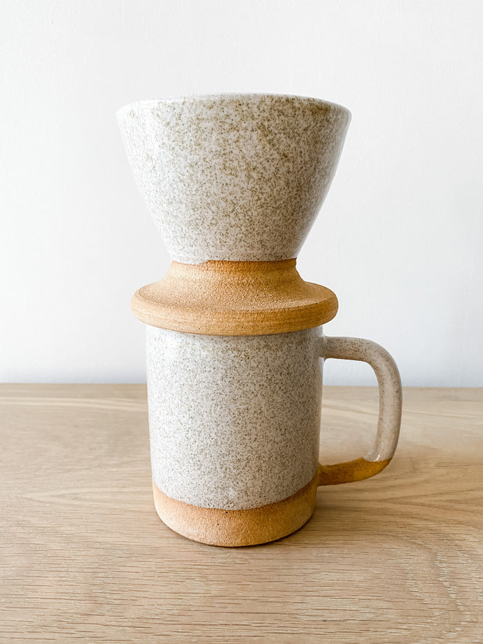 Front view of the Uzumati Ceramic Bodie Pour Over on white oak and against a white wall - Saffron and Poe