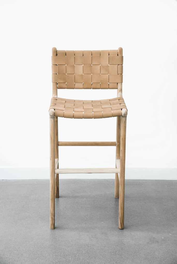 Upclose view of our comfortable, casual, Woven leather strap bar stool in beige. Handmade in Bali using Teak wood and vegetable-tanned leather imported from Java. - Saffron and Poe