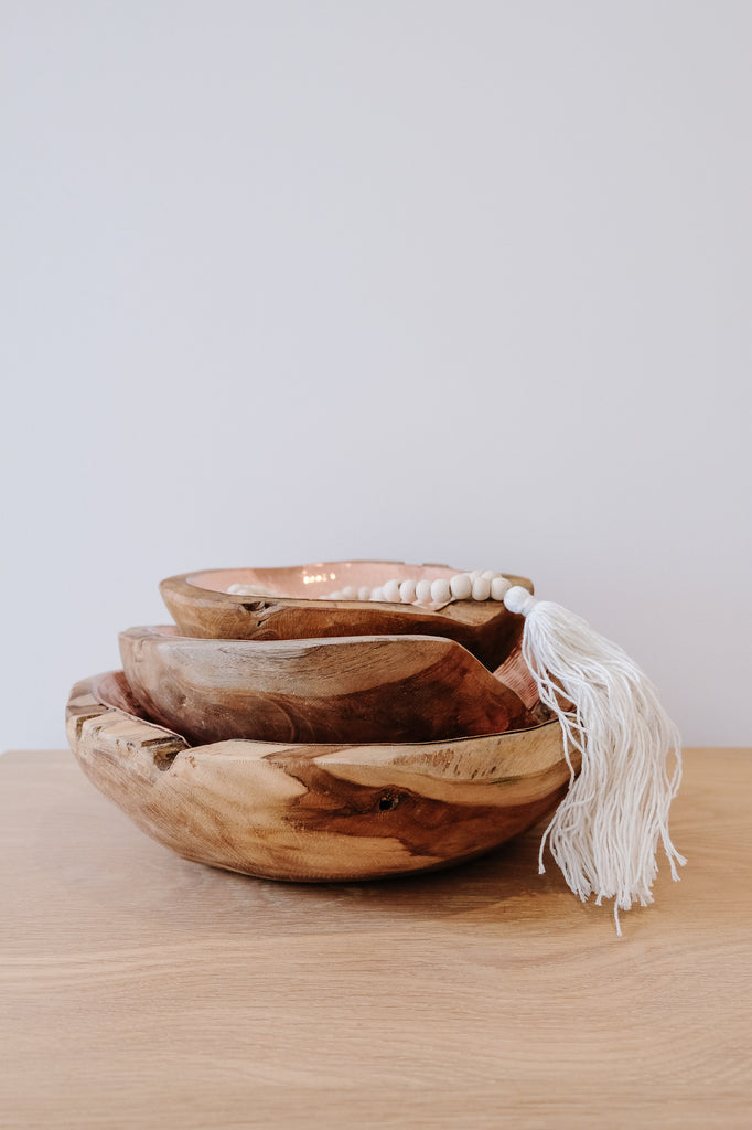 Front view of three stacked Hammered Copper and Teak Bowls. Sizes ranging from small, medium, and large with white background. Tasseled Bali Beads included. - Saffron and Poe.