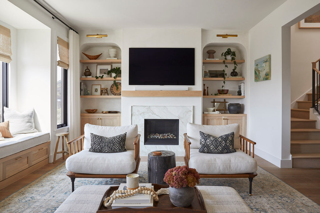 Styled Antique Miao PIllows in a contemporary living room with decorative shelves, bali beads, and a hammered copper and teak bowl. - Saffron and Poe