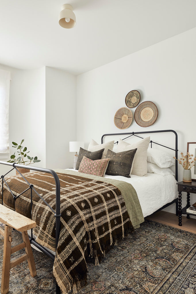 Styled view of Handwoven Bhujodi Blanket - Dark Brown on a vintage rug with Antique Chinese Bench. - Saffron and Poe