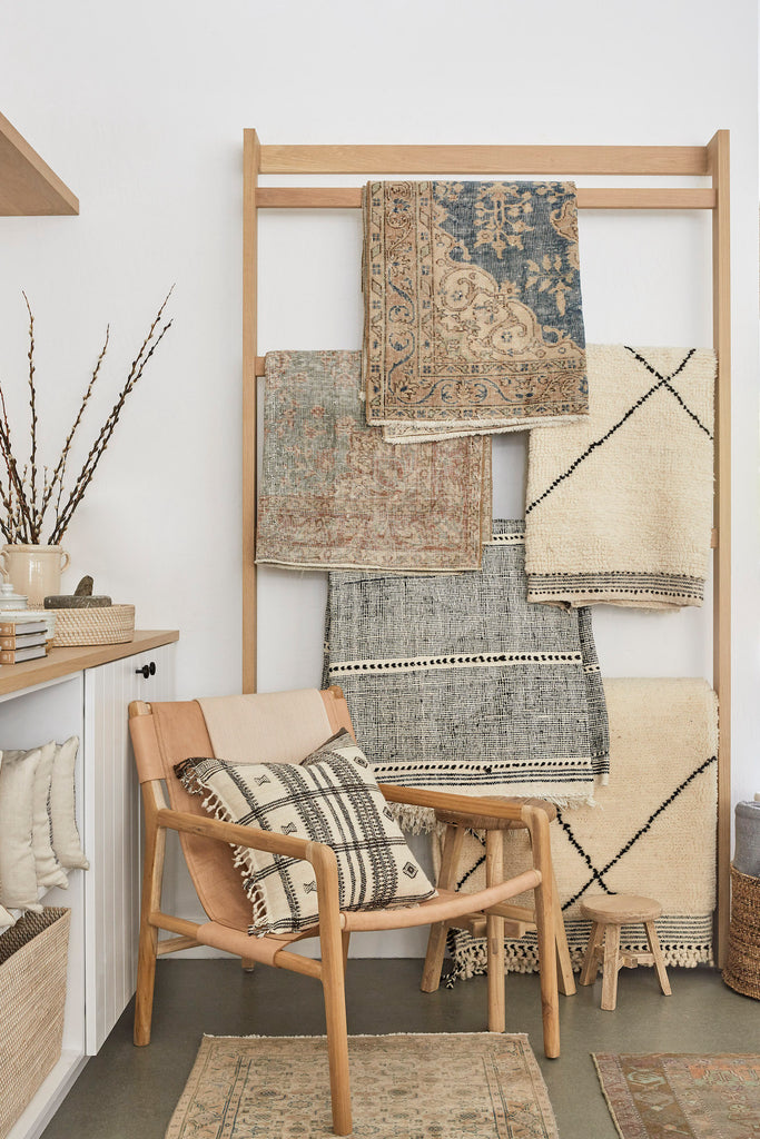 Styled Handwoven Bhujodi PIllow on a Leather Sling Lounge Chair with Vintage Turkish Rugs and Beni Ourain Rugs. - Saffron and Poe