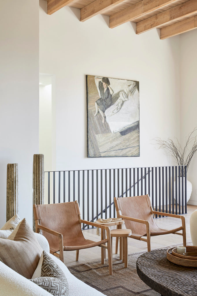 Styled Leather Sling Lounge Chairs together in an exposed ceiling living room.  - Saffron and Poe.