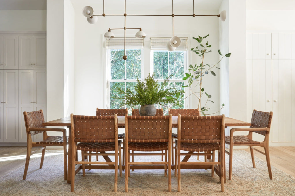 Styled photo with Saddle Woven Leather Dining Chair against white background. Furniture handcrafted in Bali. -Saffron and Poe