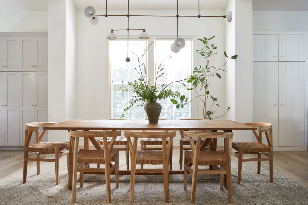 Styled photo with Vintage Mijiu Jar on top of oak table with Woven Leather Wishbone Dining Chairs. -Saffron and Poe
