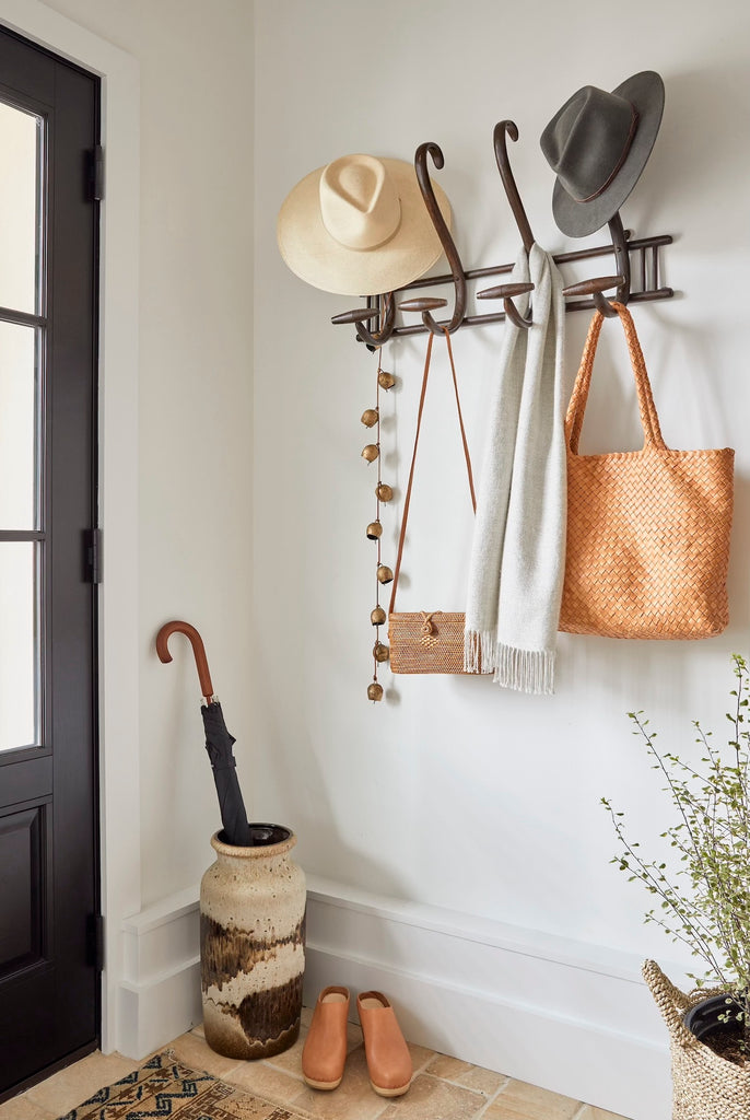 Styled photo of Alpaca Scarf - Gray hooked at an entryway with a Woven Sisal and Leather Tote bag. - Saffron + Poe