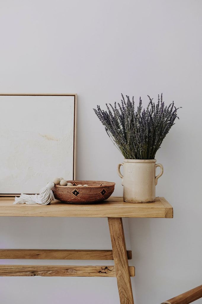 Styled Black and Natural Tenganan Basket on a wood console. - Saffron + Poe