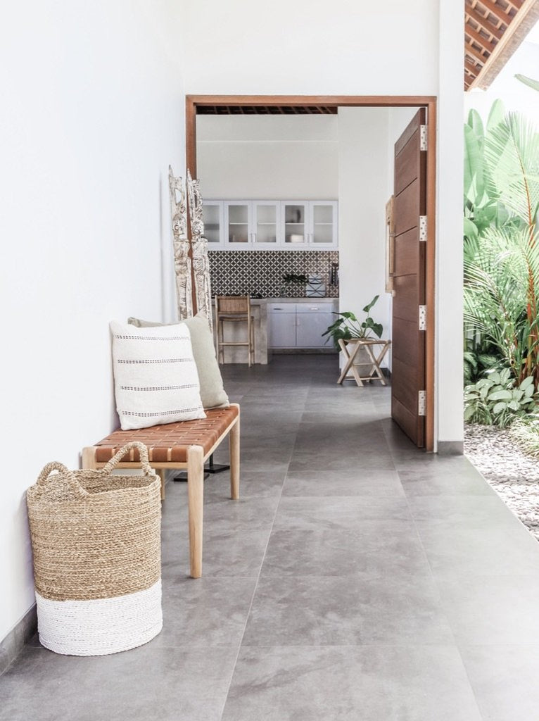 Teak framed Woven Leather Strap Bench styled in doorway with basket. Furniture Handcrafted in Bali.- Saffron and Poe