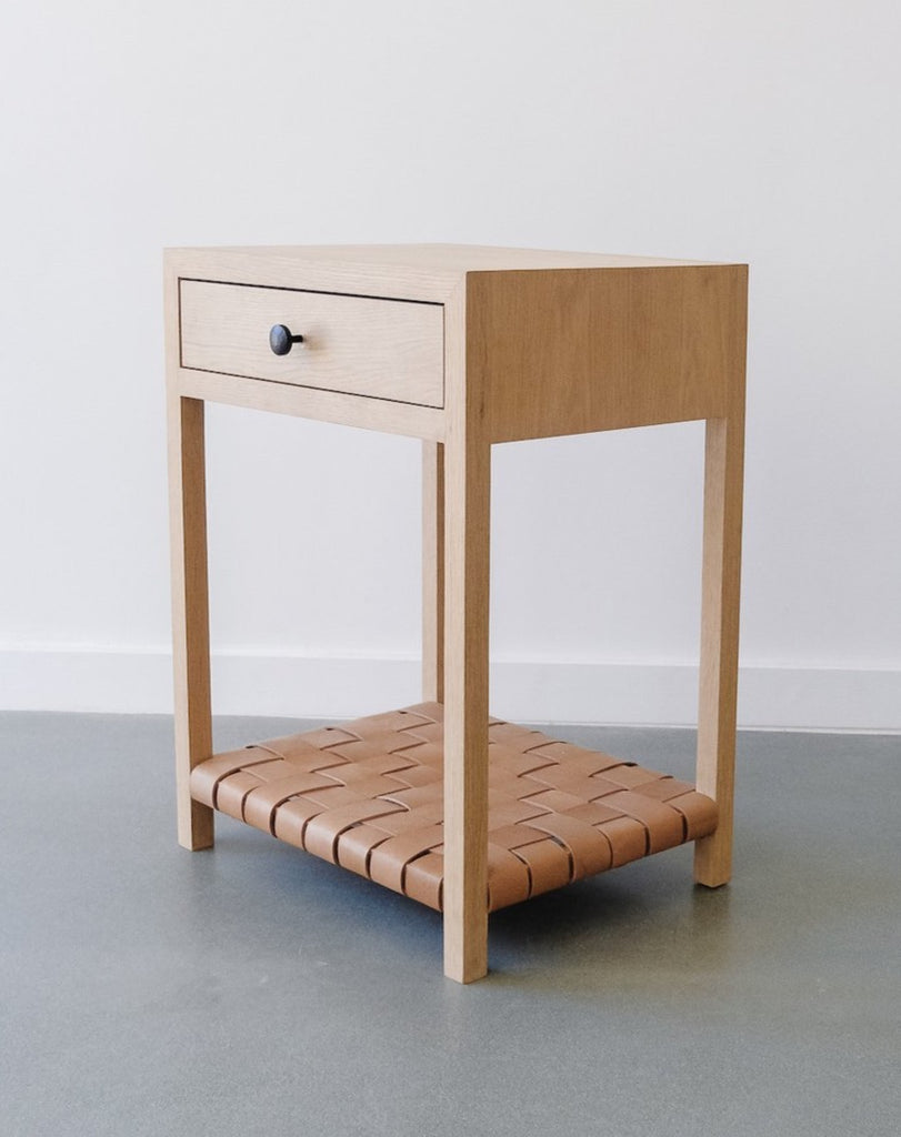 Side view of White Oak Beige Leather Strap Bedside Table against white background. Handcrafted in California. - Saffron and Poe
