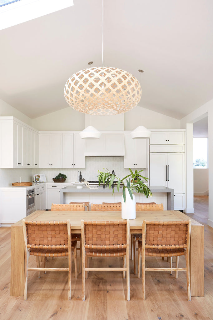 Styled Woven Leather Strap Dining Chair in a white kitchen. - Saffron and Poe