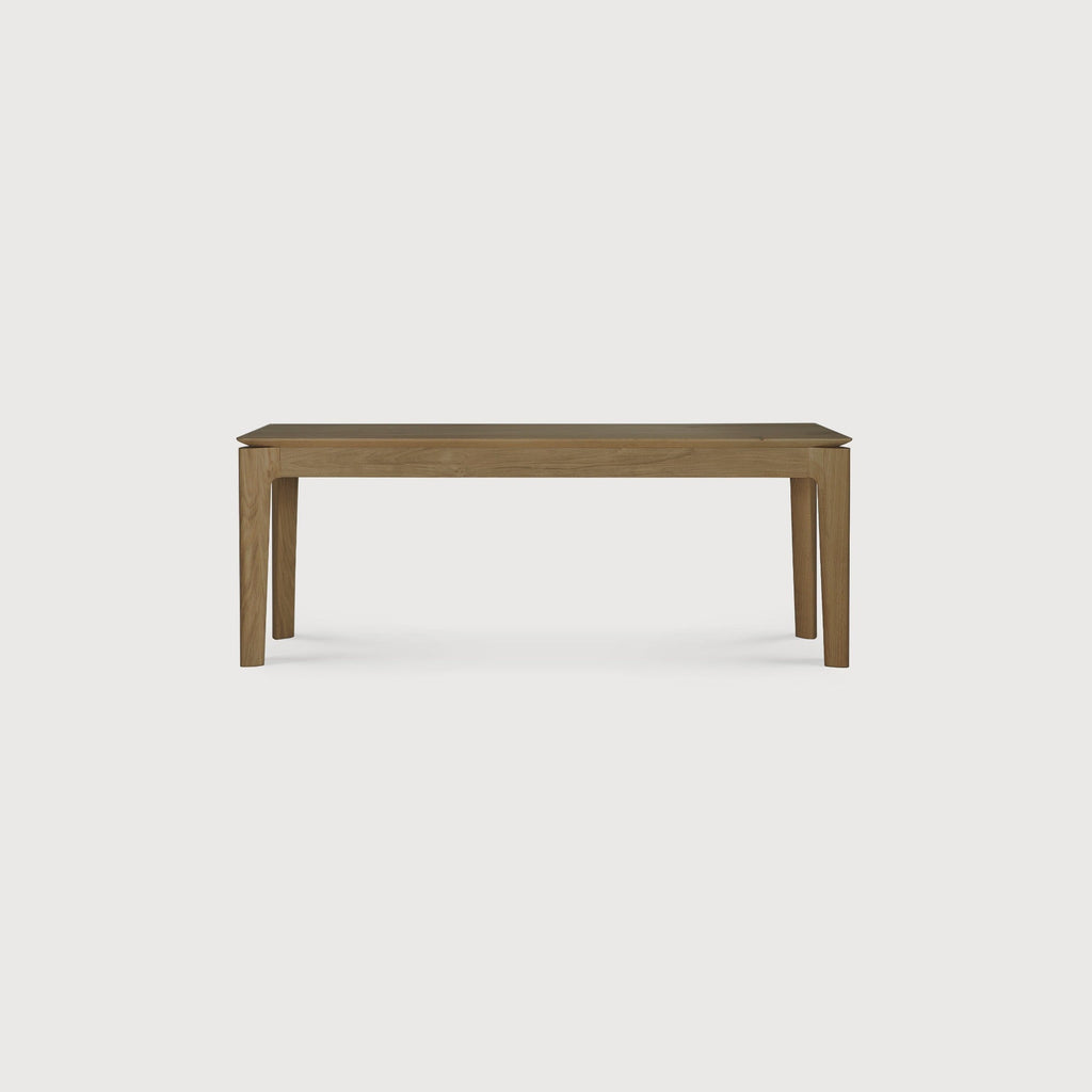 Bok Bench made of solid natural teak with contoured frame and floating bench top in natural finish