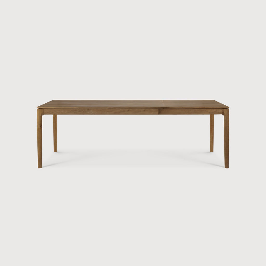 Teak Bok Extendable Dining Table side view in open position with white background, featuring floating table top and beautiful wood joinery. - Saffron and Poe, Ethnicraft