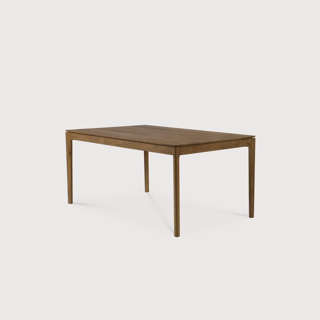 Teak Bok Extendable Dining Table with white background at an angle, with floating table top and beautiful wood joinery. - Saffron and Poe, Ethnicraft