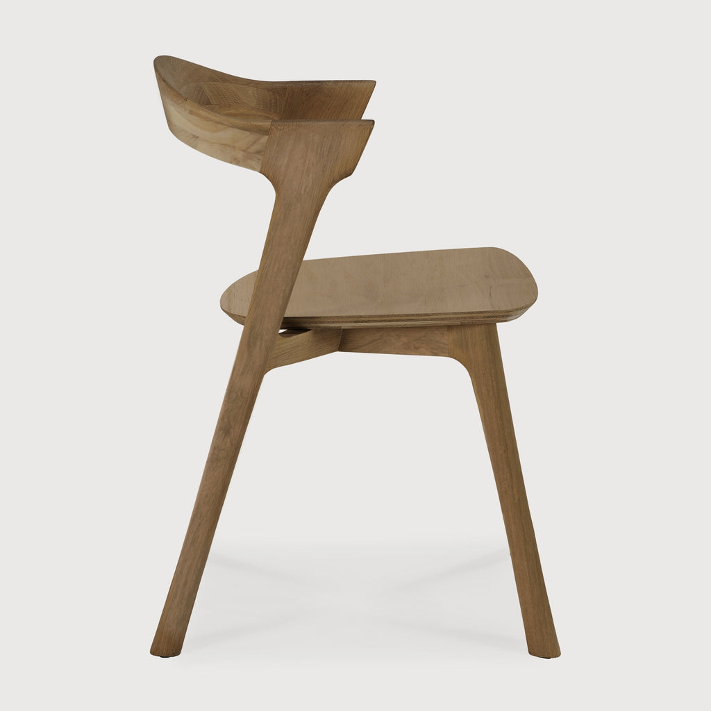 Natural Teak Bok Dining Chair side view with white background and beautiful wood joinery. - Saffron and Poe, Ethnicraft