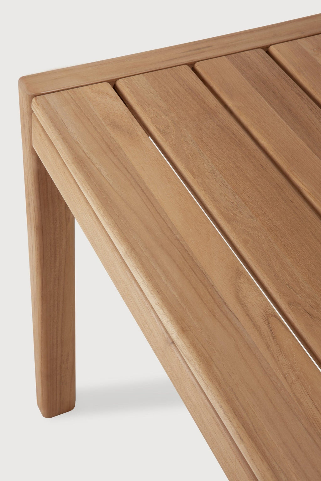 Jack Outdoor Dining Table made of solid teak with subtle curves and spacious design for elegant outdoor dining