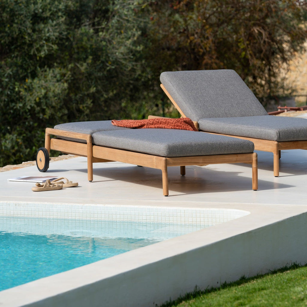 Jack Outdoor Adjustable Lounger with red cushion on solid teak frame for stylish outdoor relaxation