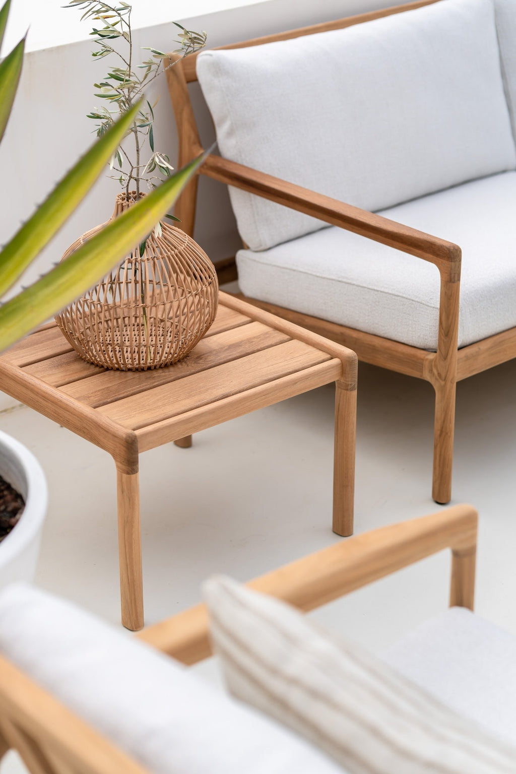 Jack Outdoor Side Table in solid teak with curved design for stylish outdoor use
