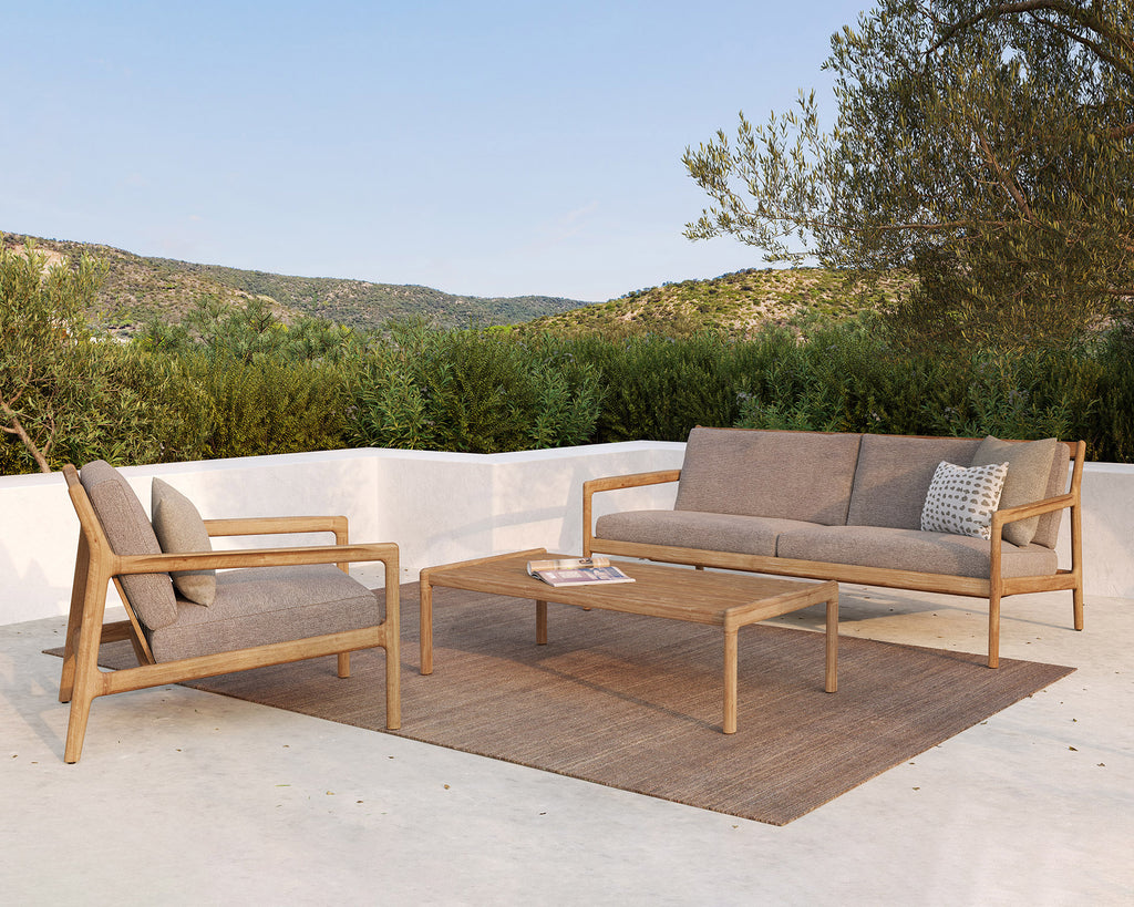 Jack Outdoor Sofa 2 Seater and mocha cushion on an outdoor patio sitting on a natural outdoor rug. - Saffron and Poe, Ethnicraft