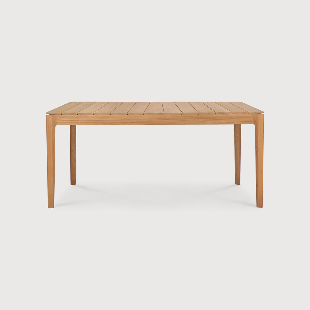 Teak Bok Outdoor Dining Table side view with white background and beautiful wood joinery. - Saffron and Poe, Ethnicraft
