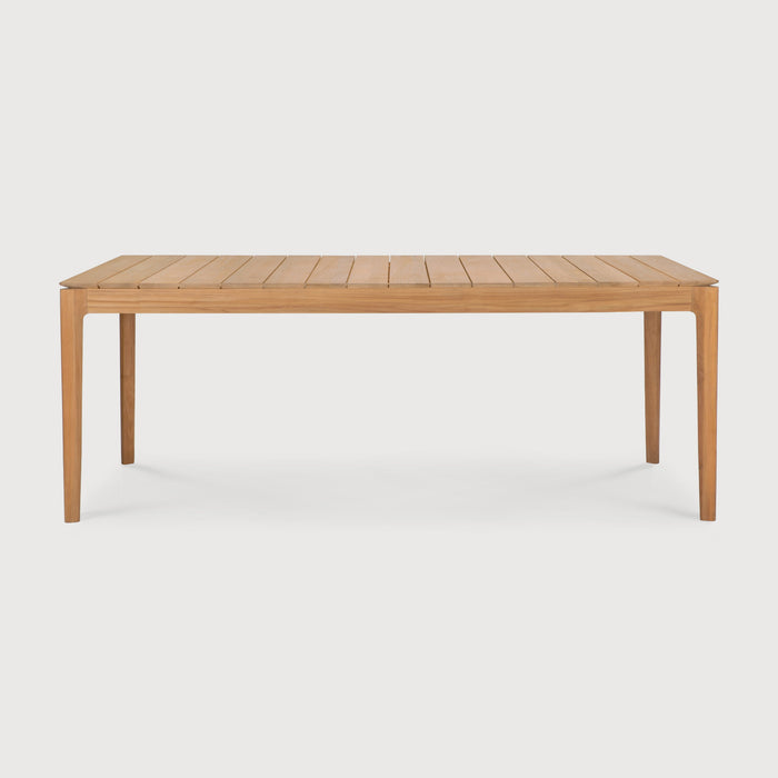 Teak Bok Outdoor Dining Table side view with white background and beautiful wood joinery. - Saffron and Poe, Ethnicraft