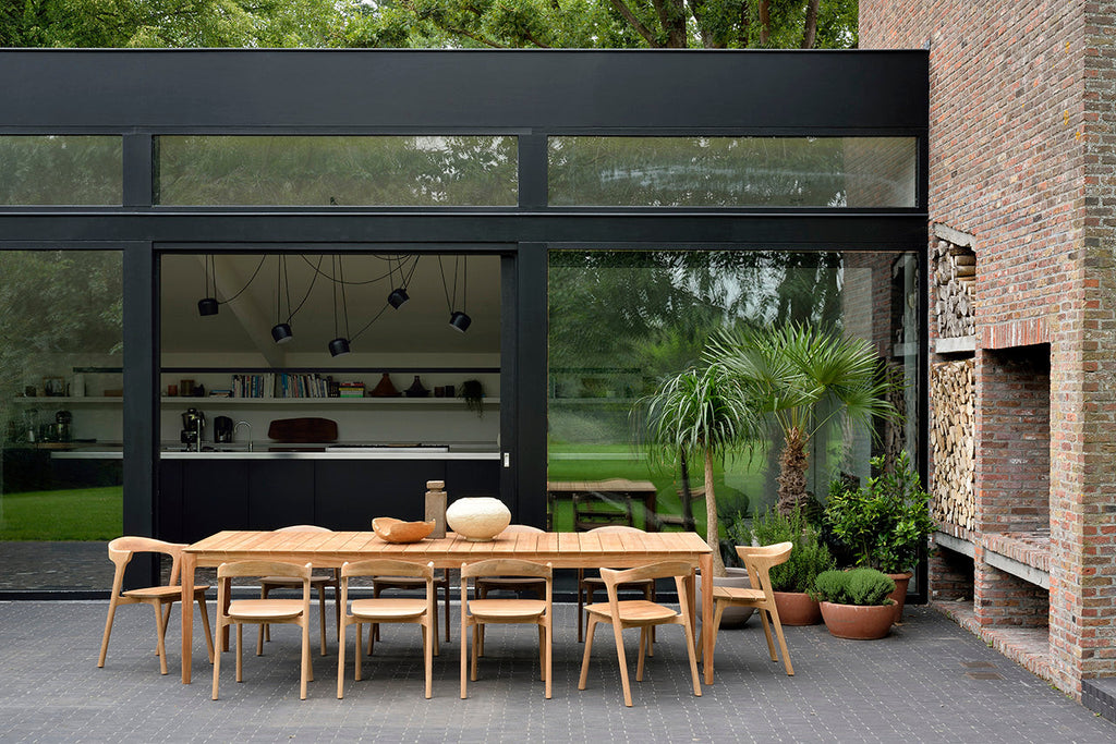 Bok Outdoor Dining Chair made of solid teak with sculptural, airy design and neutral fabric cushion