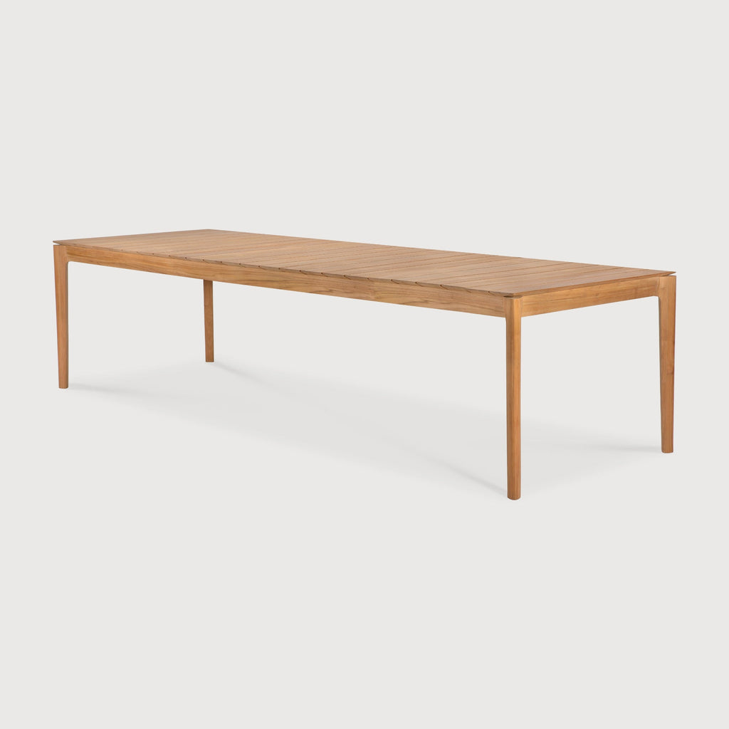 Bok Outdoor Dining Table made of teak with sculptural, airy design and slatted tabletop for modern outdoor spaces