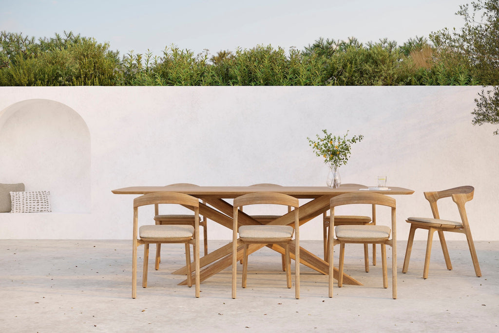 Bok Outdoor Dining Chair in solid teak with neutral fabric cushion and sculptural frame