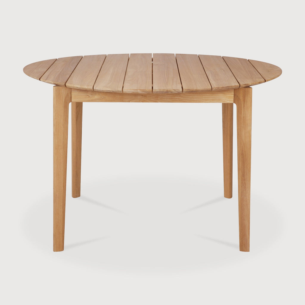 Bok Circle Outdoor Dining Table in teak with sculptural, airy design outdoors
