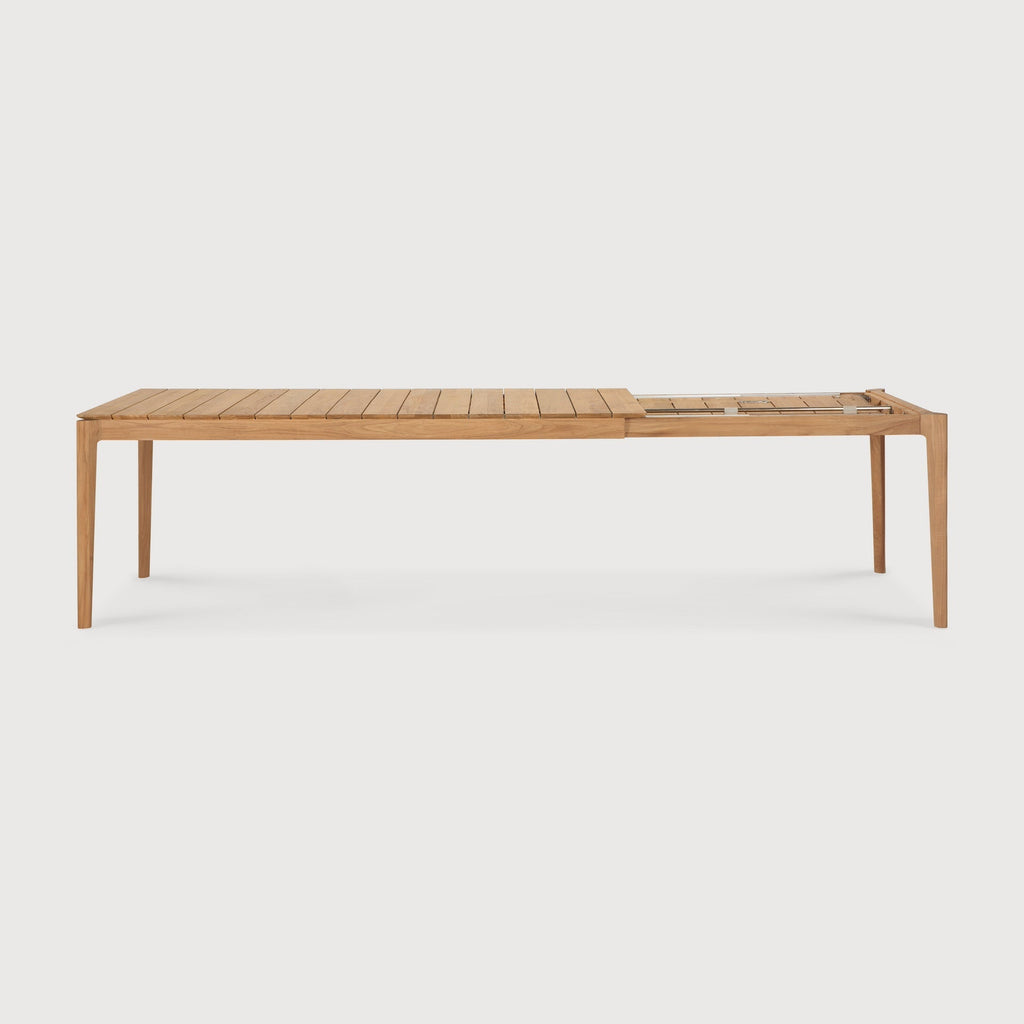 Bok Outdoor Extendable Dining Table in teak wood, open slatted design, shown extended for outdoor seating up to 12 people