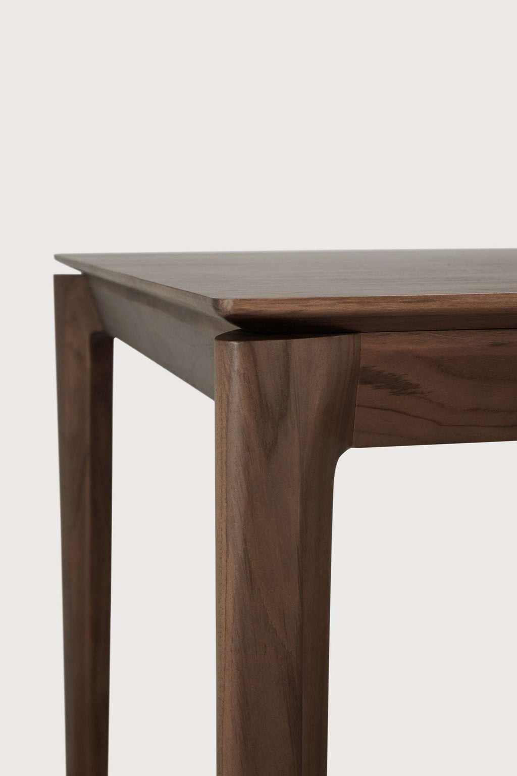 Bok Dining Table in dark teak with contoured frame and floating top, handcrafted from solid teak wood