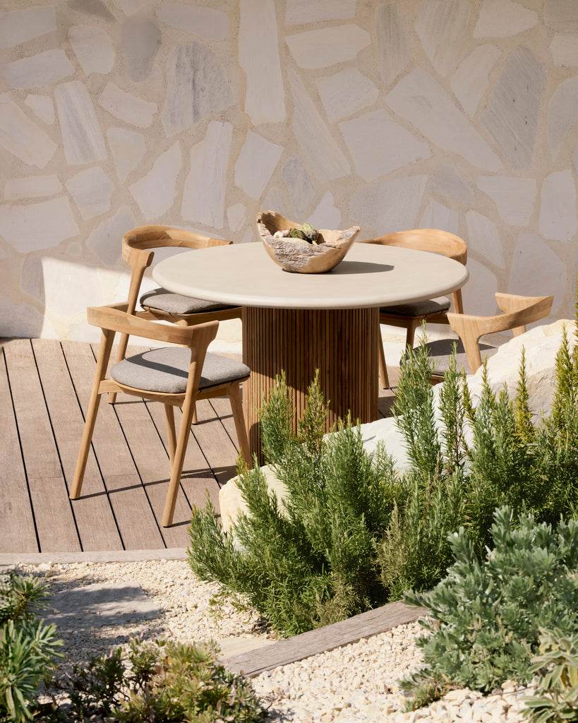 Round outdoor table with slatted reclaimed teak base and concrete top table styled on deck with Bok Dining Chairs. - Saffron and Poe, Ethnicraft