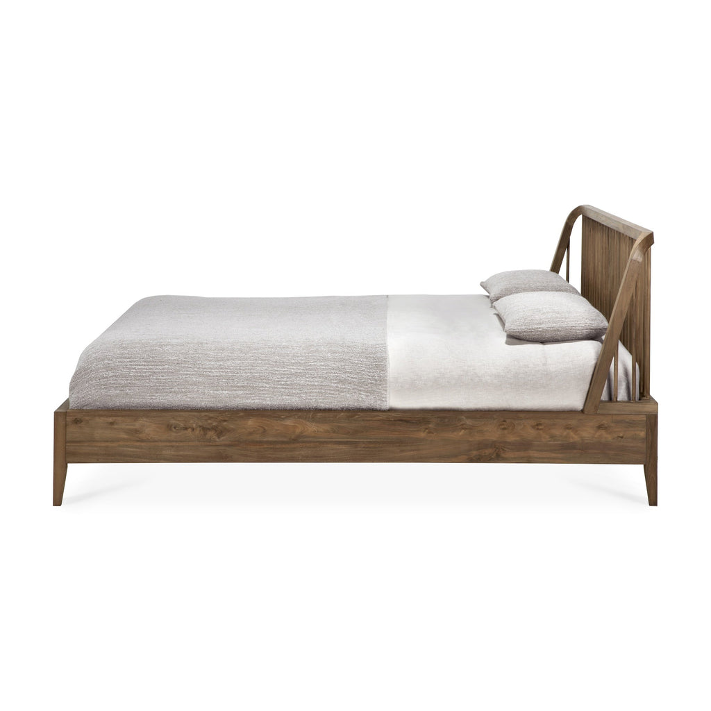 Dark teak spindle bed with curved edges and classic headboard design