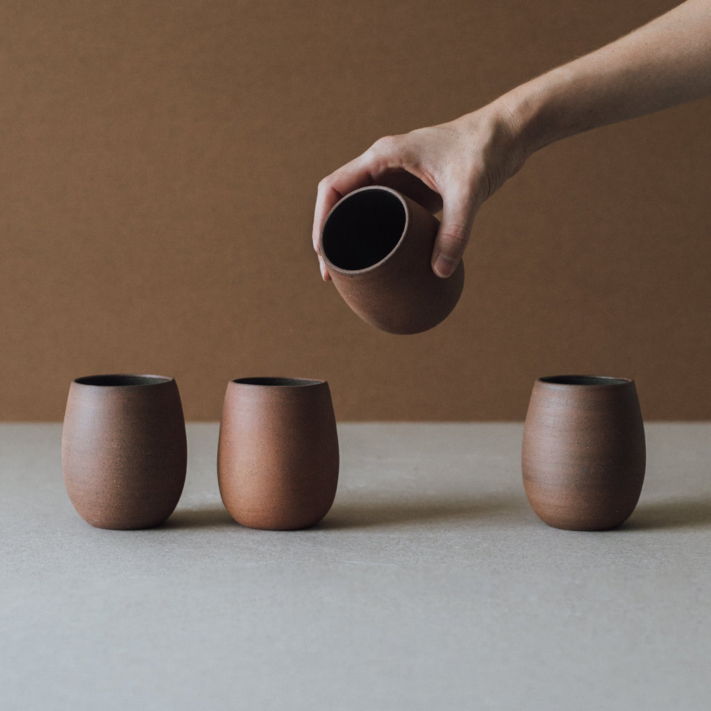 Handcrafted Bola Cup made of ceramic and local clay with natural earth tones and kiln-fired textures.