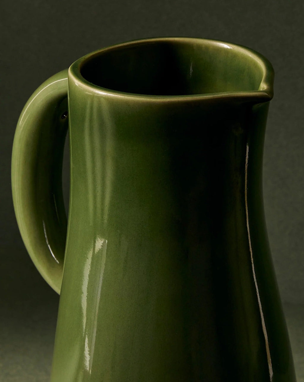 Handcrafted Dadasi Green stoneware jug with bold silhouette and rich glaze, holding 50 oz, handmade in Tunisia