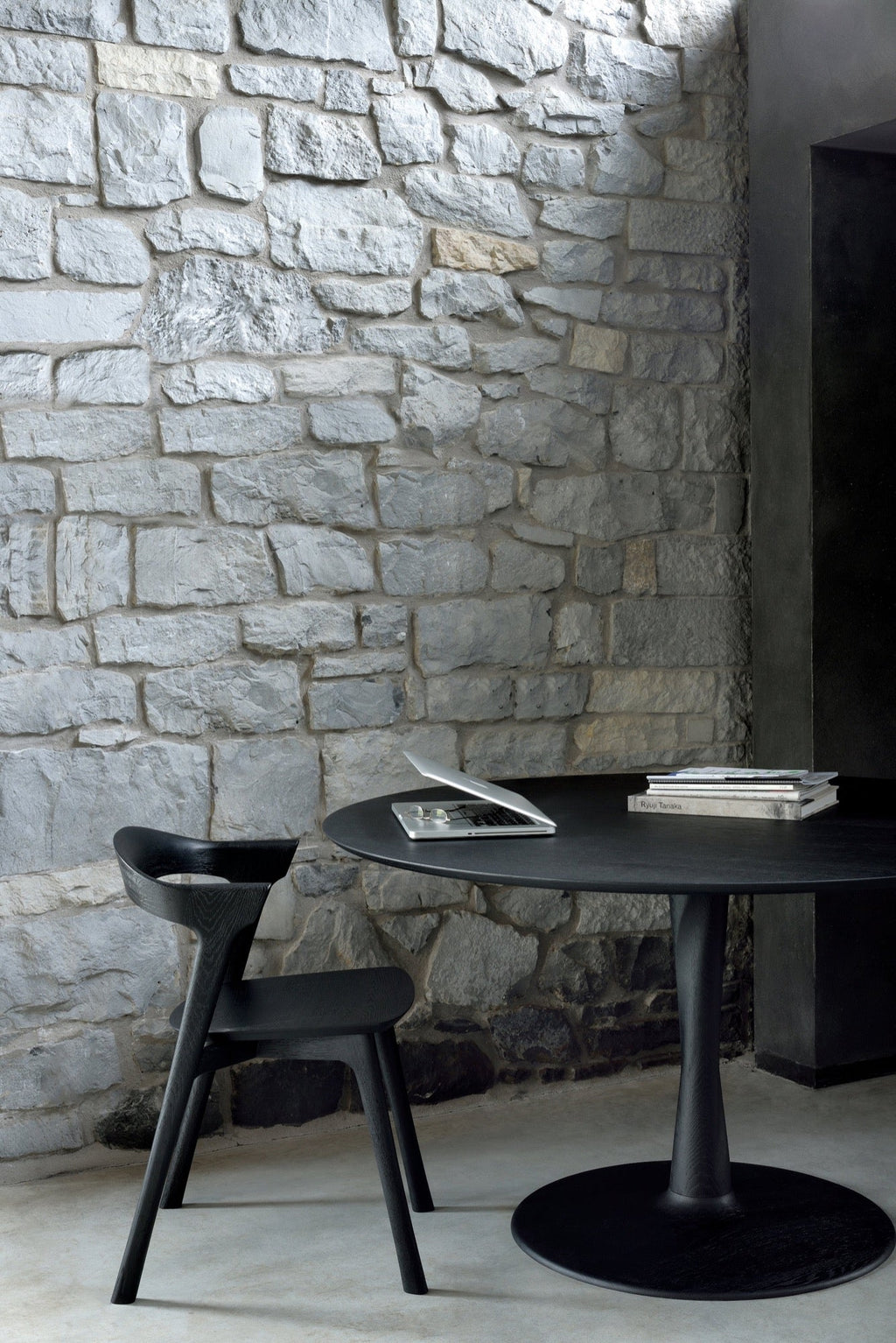 Torsion Dining Table in black oak with sculptural twisted pedestal base and round top